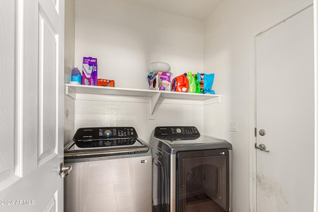 washroom with washing machine and clothes dryer