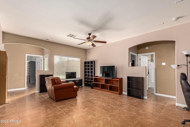 tiled living room with ceiling fan