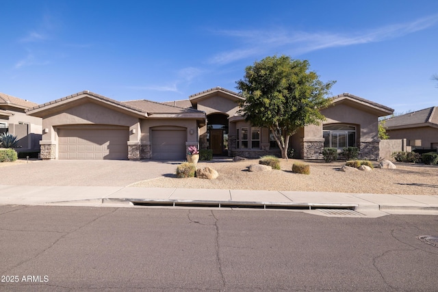 view of front of property featuring a garage, driveway, stone siding, a tiled roof, and stucco siding