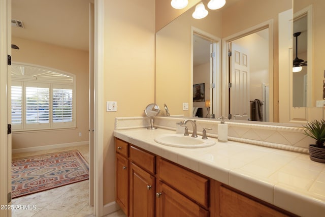 bathroom with visible vents, vanity, and baseboards