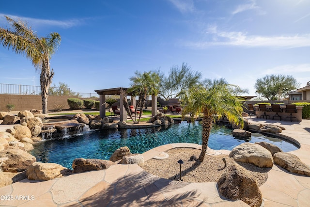 view of swimming pool with fence, outdoor dry bar, a fenced in pool, and a patio