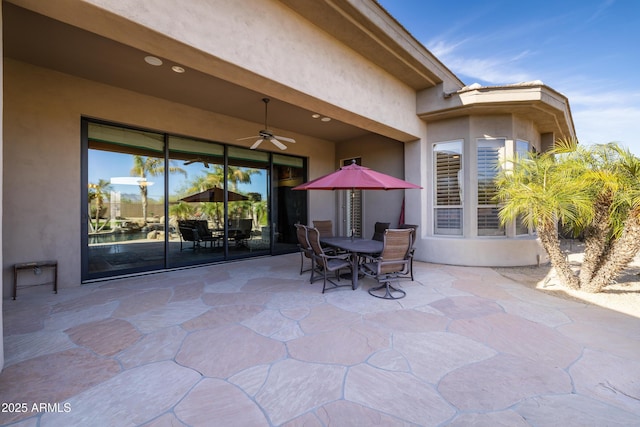 view of patio / terrace with ceiling fan and outdoor dining area