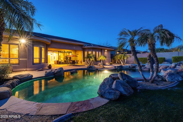 view of swimming pool featuring a patio, fence, and a fenced in pool