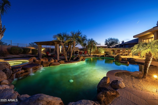 pool at dusk featuring a fenced in pool, a patio area, fence, and an in ground hot tub