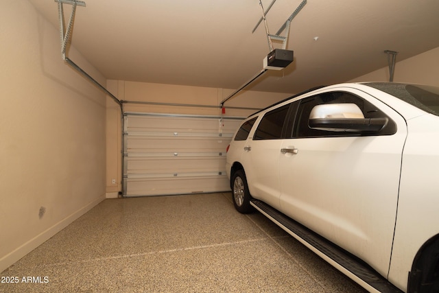 garage with a garage door opener and baseboards