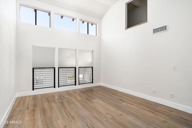 4434 E Camelback Rd Unit 132, Phoenix, AZ 85018 - spare room with wood finished floors and high vaulted ceiling