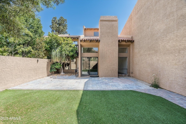 4434 E Camelback Rd Unit 132, Phoenix, AZ 85018 - rear view of house featuring a patio, stucco siding, a tile roof, and a chimney