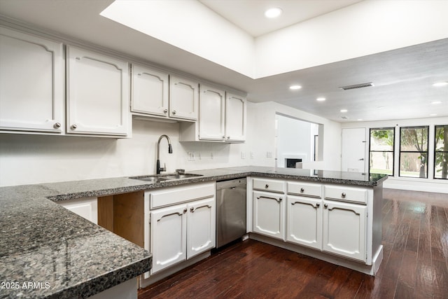 4434 E Camelback Rd Unit 132, Phoenix, AZ 85018 - kitchen with stainless steel dishwasher, a peninsula, recessed lighting, dark wood-style floors, and dark stone counters