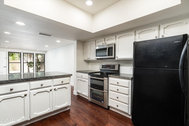 4434 E Camelback Rd Unit 132, Phoenix, AZ 85018 - kitchen featuring stainless steel appliances, dark wood finished floors, dark stone countertops, recessed lighting, and white cabinetry