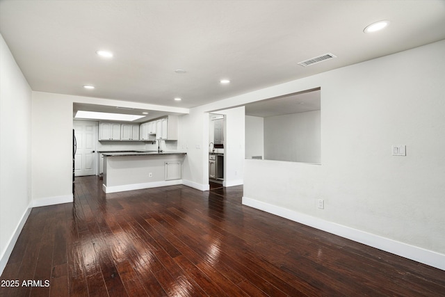 4434 E Camelback Rd Unit 132, Phoenix, AZ 85018 - unfurnished living room with dark wood finished floors and recessed lighting