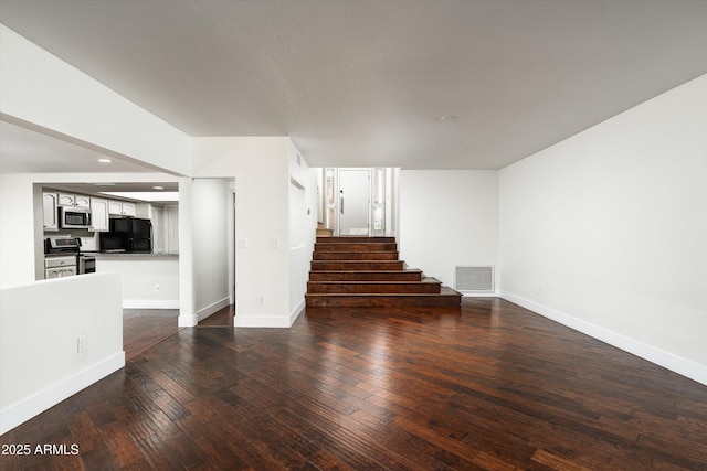 4434 E Camelback Rd Unit 132, Phoenix, AZ 85018 - unfurnished living room with stairway, dark wood-style flooring, and recessed lighting