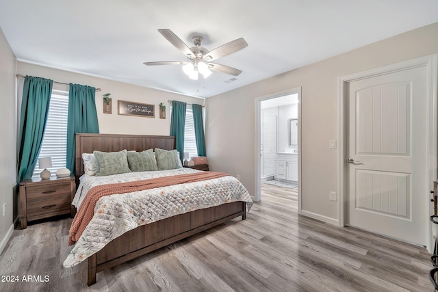 bedroom featuring ceiling fan, connected bathroom, and light hardwood / wood-style flooring