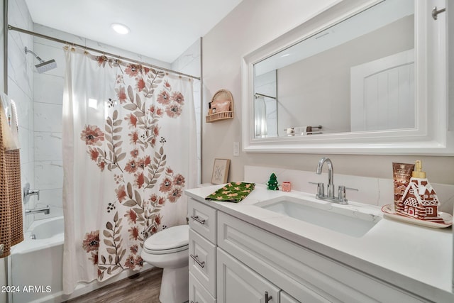 full bathroom featuring hardwood / wood-style flooring, vanity, toilet, and shower / tub combo with curtain