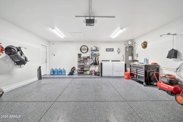 garage with water heater, a garage door opener, and independent washer and dryer