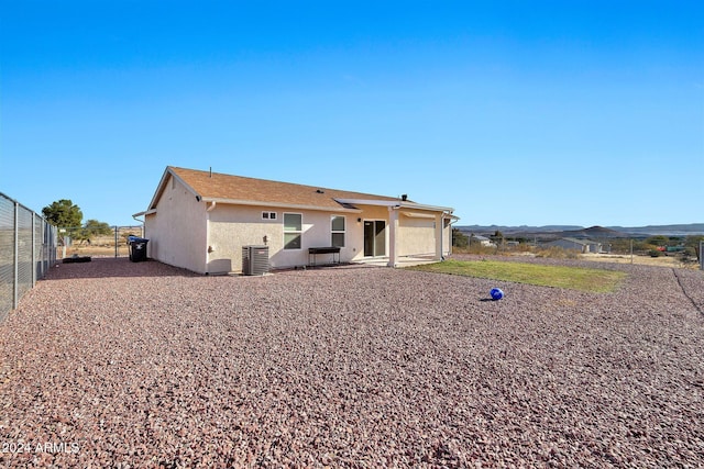 back of house with central AC and a mountain view