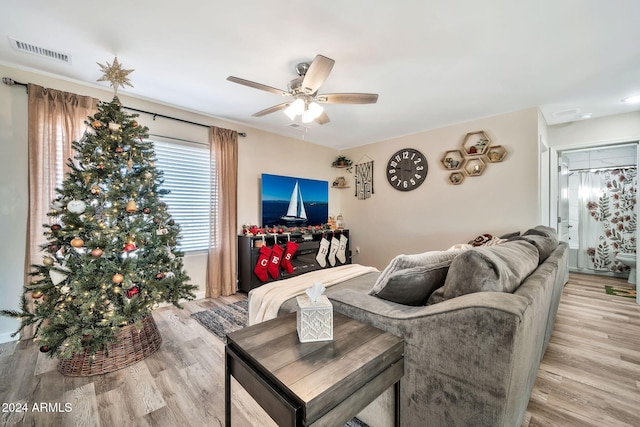 living room featuring ceiling fan and light hardwood / wood-style floors