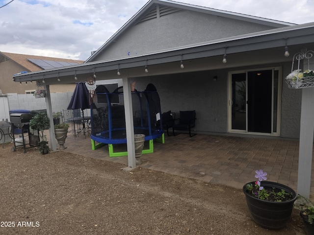 11770 W Aster Dr, El Mirage, AZ 85335 - back of house featuring a patio area, stucco siding, and fence