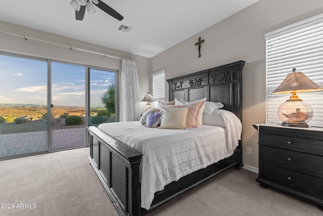 carpeted bedroom featuring access to outside and ceiling fan