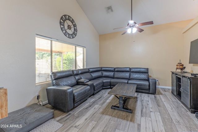 living room with ceiling fan, light hardwood / wood-style floors, and high vaulted ceiling