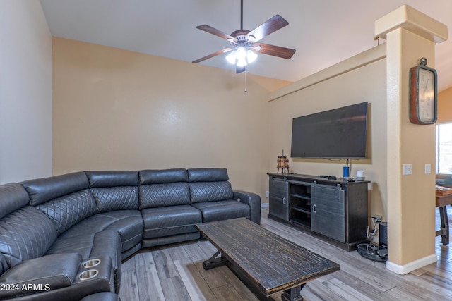 living room with lofted ceiling, ceiling fan, and light hardwood / wood-style flooring