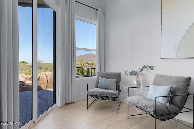 sitting room featuring plenty of natural light and wood finished floors