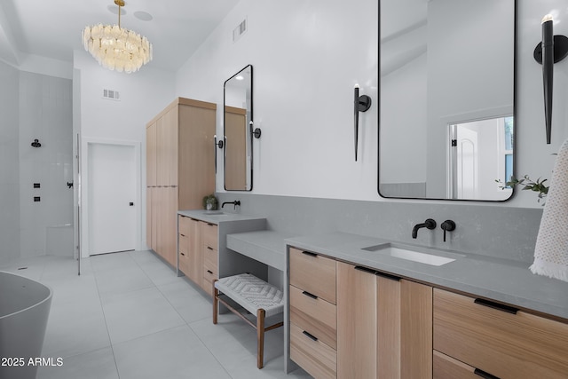 full bathroom with visible vents, walk in shower, a notable chandelier, a sink, and two vanities