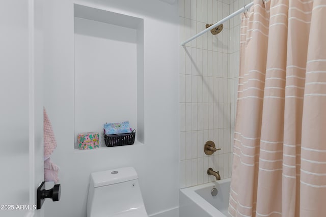 bathroom featuring shower / bath combo with shower curtain and toilet