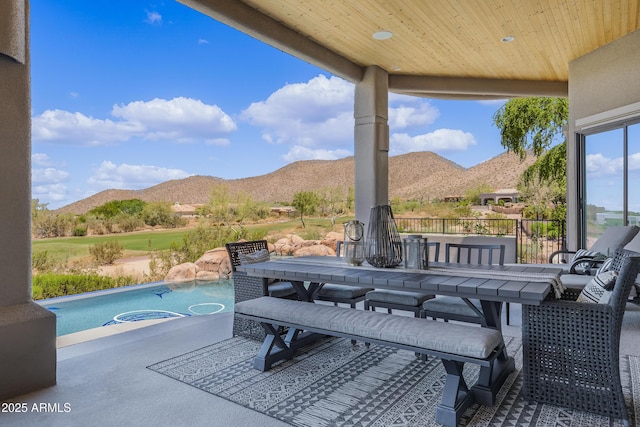view of patio / terrace featuring outdoor dining space and a mountain view