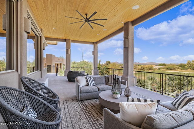 view of patio / terrace featuring a mountain view, outdoor lounge area, and a ceiling fan