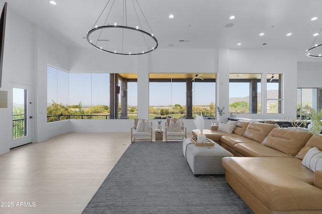 sunroom / solarium featuring a healthy amount of sunlight, an inviting chandelier, and visible vents