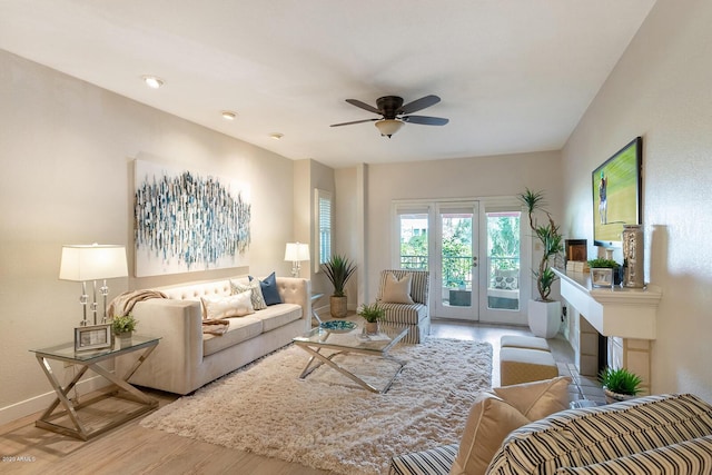 living room featuring hardwood / wood-style flooring, ceiling fan, and french doors