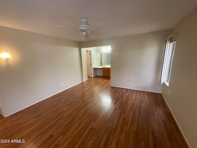 spare room featuring dark hardwood / wood-style floors and ceiling fan