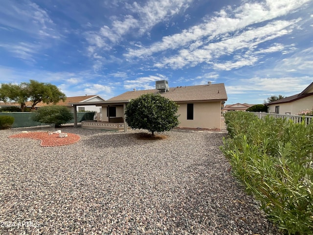 rear view of property featuring central AC unit and a patio