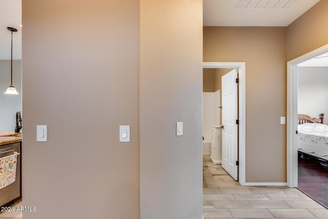 hallway with sink and light wood-type flooring