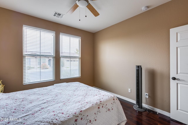 bedroom with ceiling fan and dark hardwood / wood-style flooring