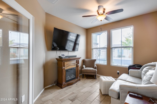 living room featuring ceiling fan and light hardwood / wood-style flooring