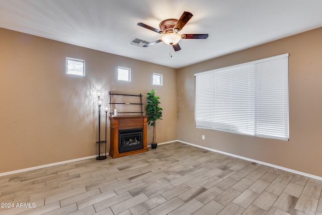 unfurnished living room featuring ceiling fan and light hardwood / wood-style floors