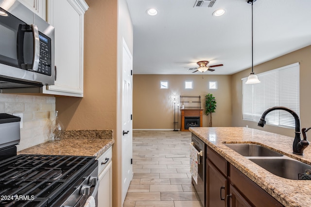 kitchen with white cabinets, stainless steel appliances, plenty of natural light, and sink