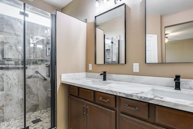 bathroom featuring vanity, an enclosed shower, and ceiling fan