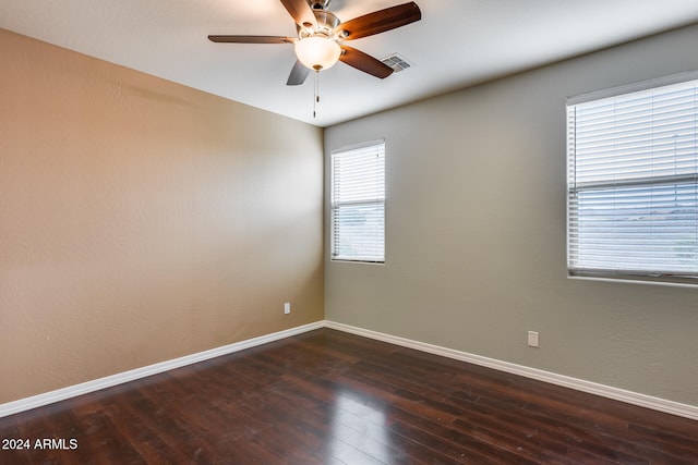 empty room featuring dark hardwood / wood-style flooring and ceiling fan