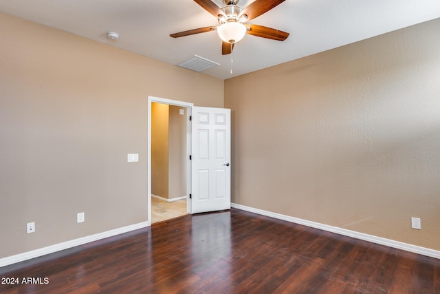 spare room featuring ceiling fan and dark hardwood / wood-style floors