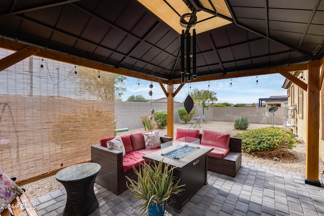 view of patio featuring a gazebo and an outdoor living space with a fire pit