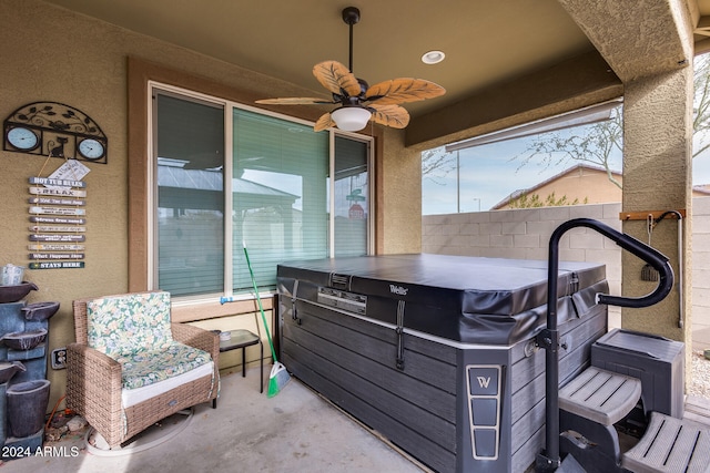 view of patio featuring a hot tub and ceiling fan