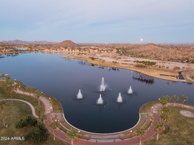 birds eye view of property with a water and mountain view