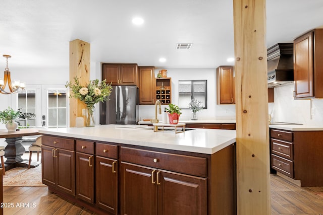 kitchen with premium range hood, dark wood-style flooring, visible vents, freestanding refrigerator, and open shelves