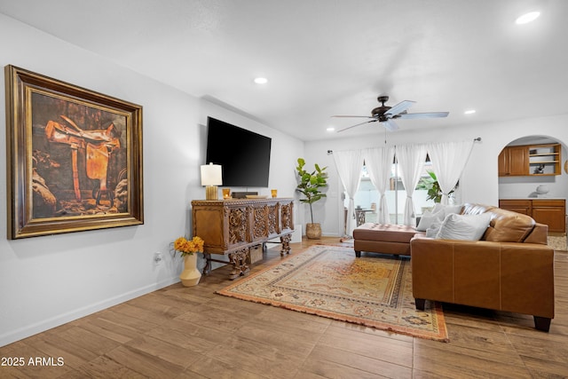 living area featuring recessed lighting, a ceiling fan, and baseboards