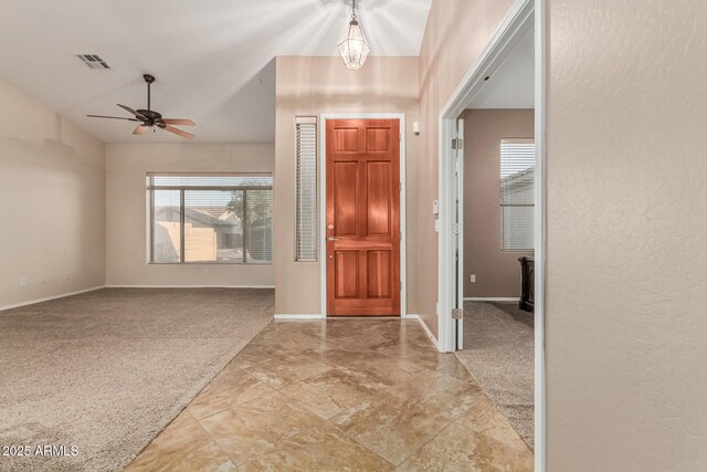 entrance foyer with light colored carpet and baseboards