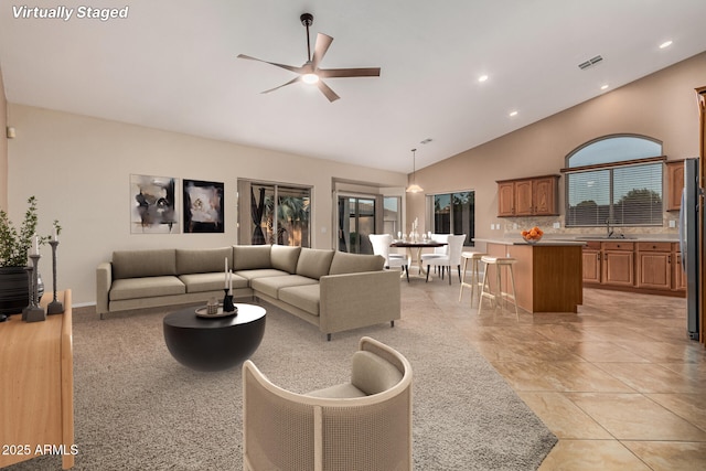 living room with high vaulted ceiling, recessed lighting, visible vents, and a ceiling fan