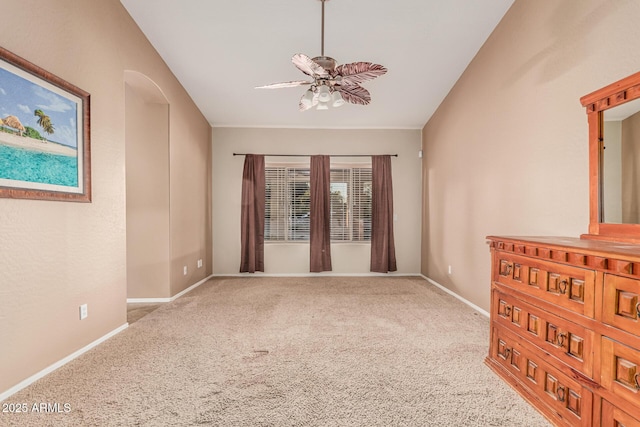 spare room featuring carpet, baseboards, and a ceiling fan