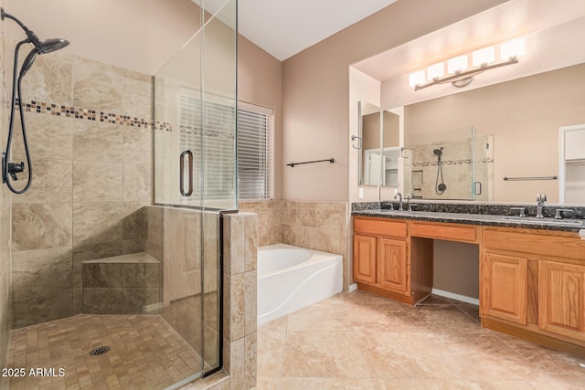 full bath with double vanity, a garden tub, a sink, and a stall shower